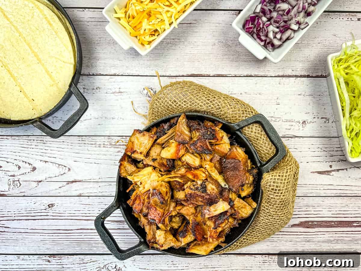 Carnitas in a round black dish.