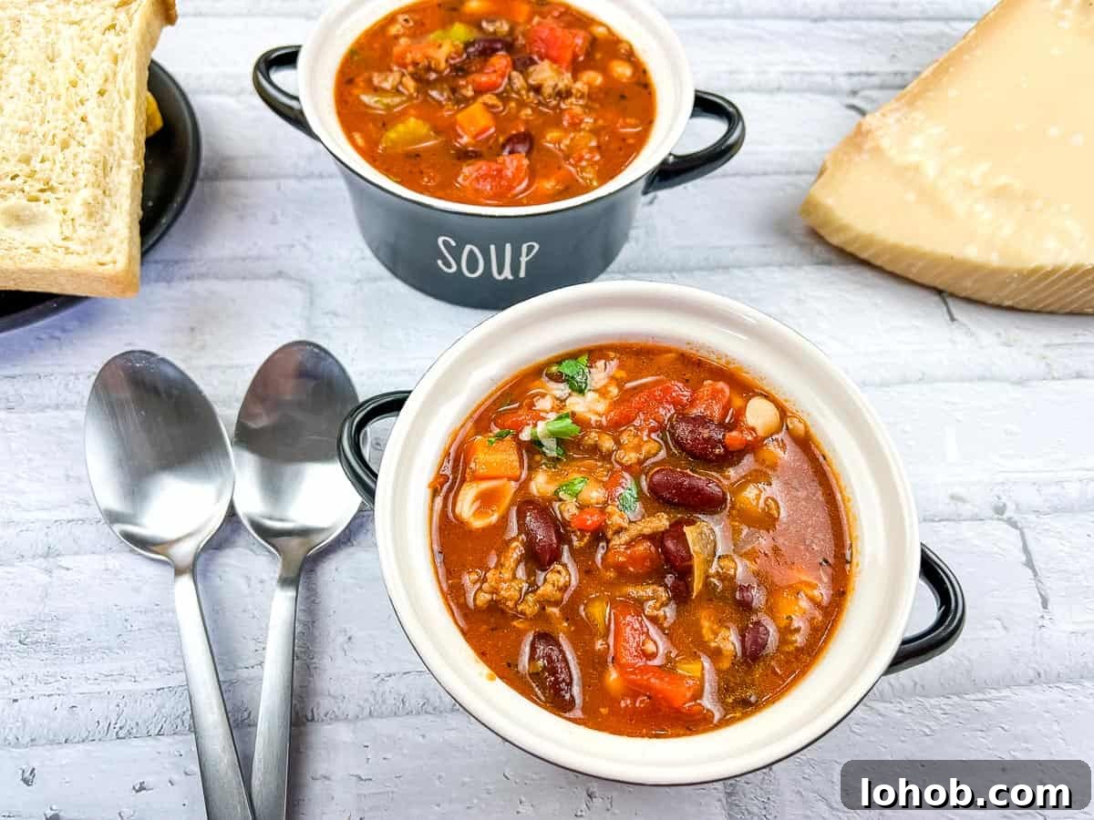 Pasta e Fagioli Soup in 2 bowls with spoons.