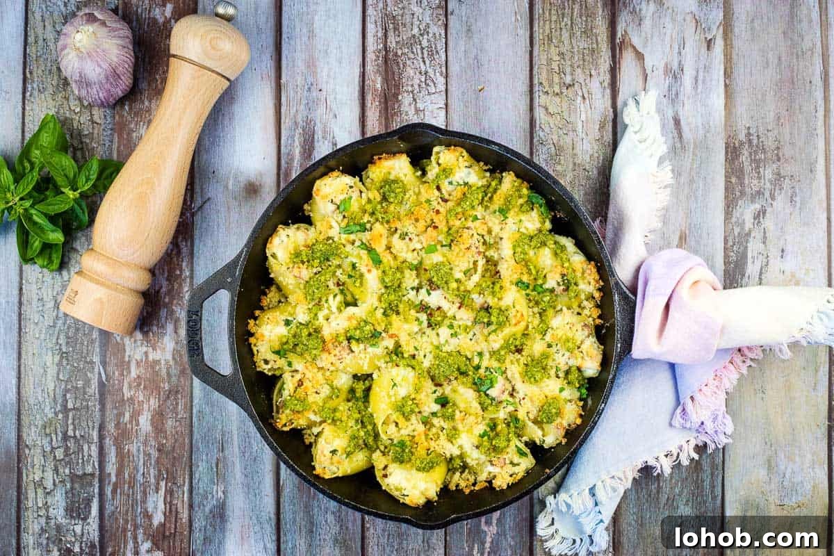 Turkey and Pesto Stuffed Pasta Shells in a black cast iron dish.