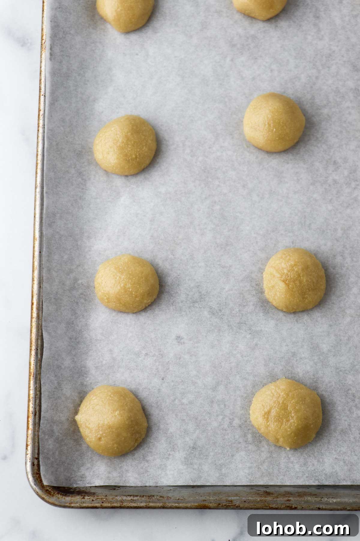 Unbaked Almond Macaroons on a baking sheet.