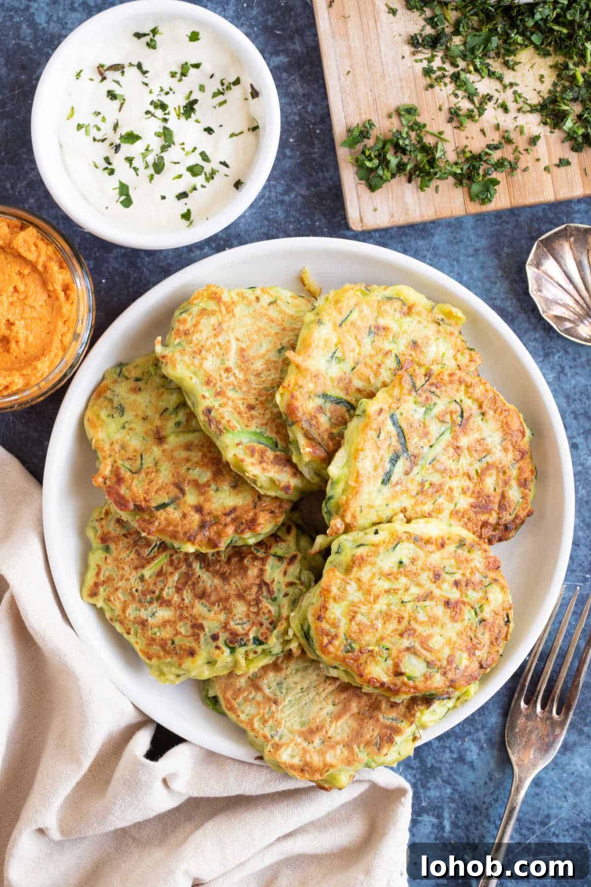 Cheesy Zucchini Fritters Recipe: Crispy Pan-Fried Rounds 5 A plate of courgette and halloumi fritters.
