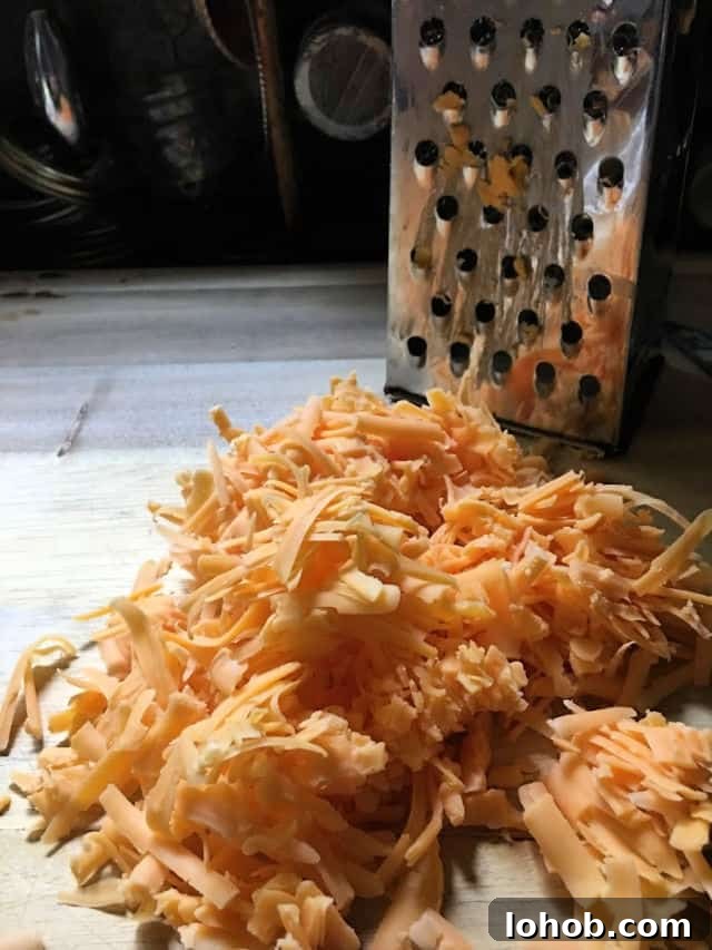 cheese grated with grater and cutting board