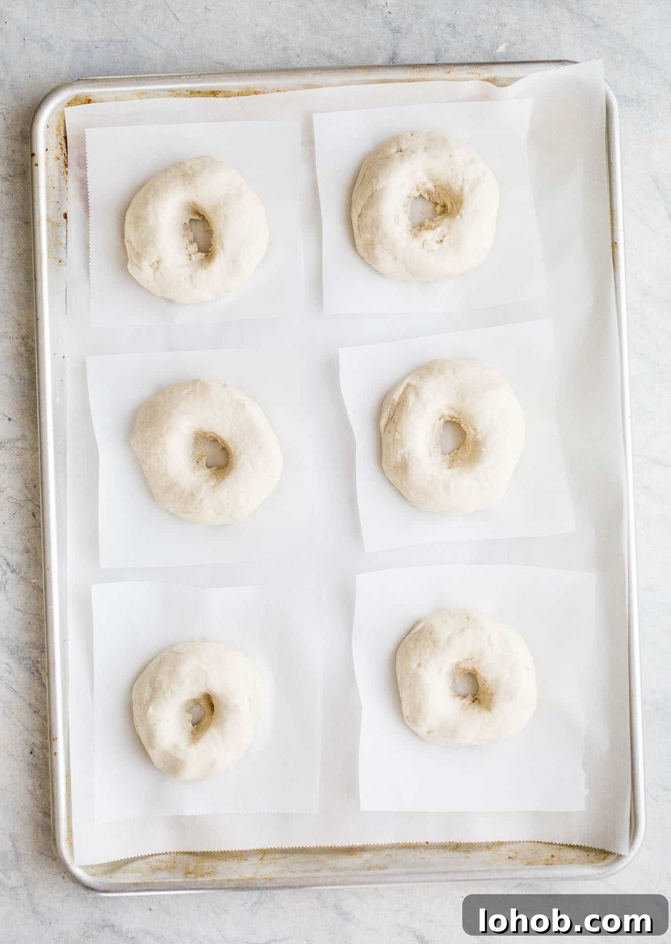 Vegan Gluten-Free Bagel Recipe: Homemade Soft & Chewy Bagels 3 Proofed bagels on a baking sheet.