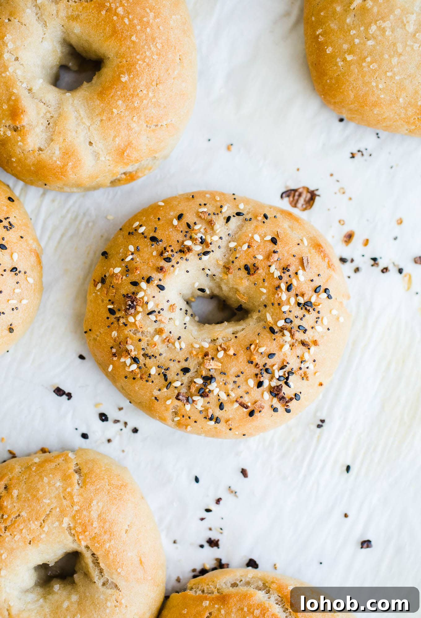 Vegan Gluten-Free Bagel Recipe: Homemade Soft & Chewy Bagels 5 Baked bagels on a baking sheet.