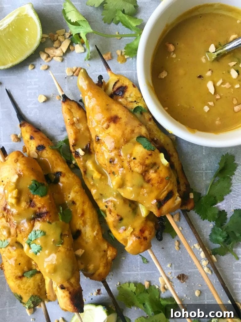 Top Weight Watchers Chicken Recipes: Quick Low-Point Meals 9 Chicken Satay Skewers on a Baking Pan with Creamy peanut sauce, crushed peanuts, and lime wedges
