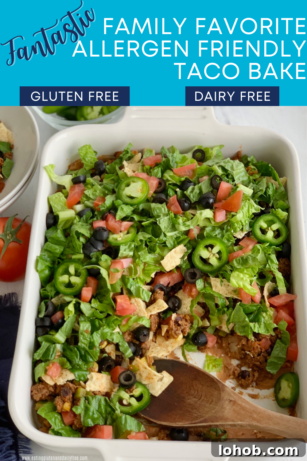 Gluten-Free Dairy-Free Taco Bake Recipe for Weeknight Dinners 2 A baking dish filled with a layer of refried beans, taco meat sauce, crunched up chips, shredded romaine lettuce, diced tomatoes, jalapeno peppers, and black olives. Several scoops have been taken out.