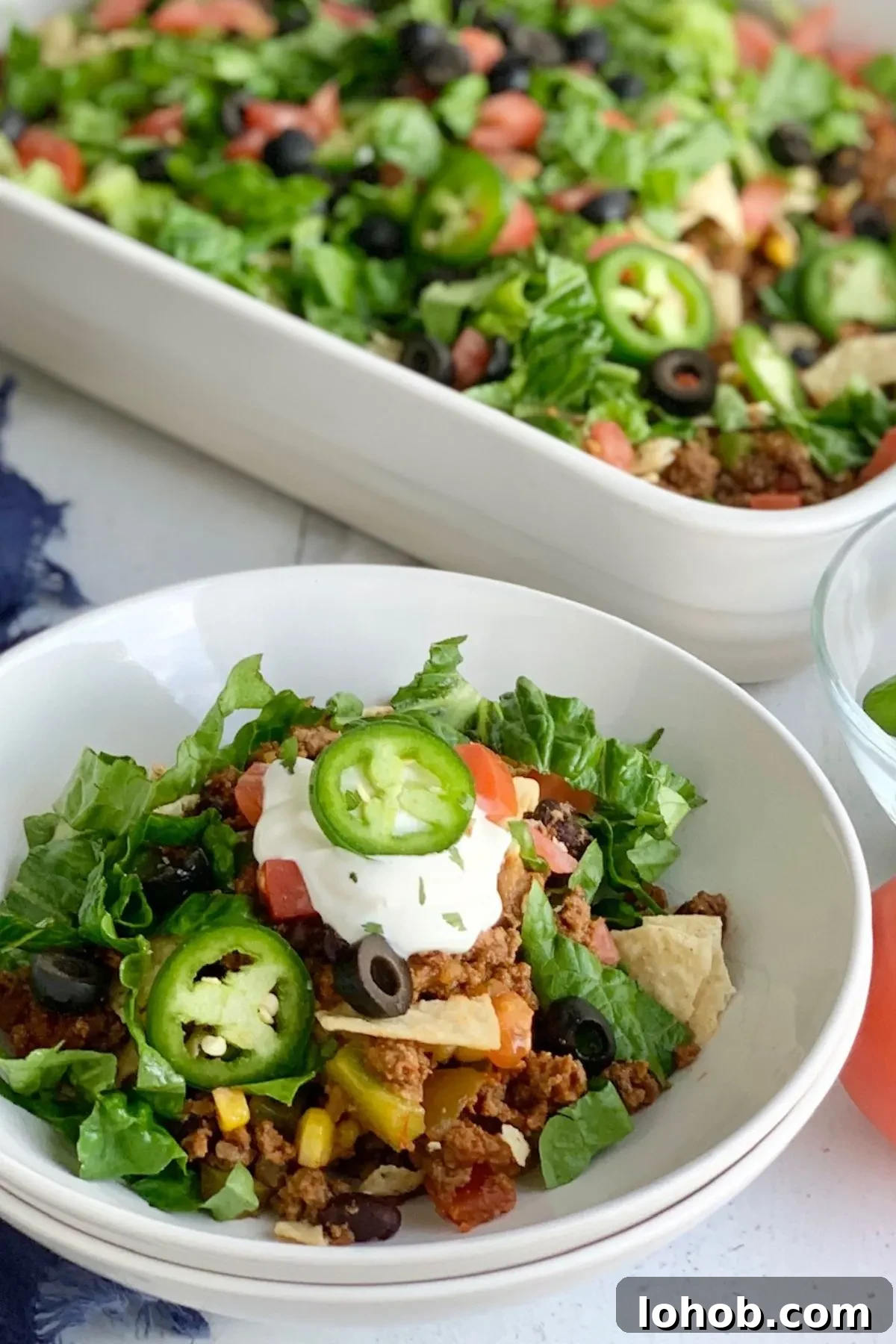 Gluten-Free Dairy-Free Taco Bake Recipe for Weeknight Dinners 3 A bowl of Gluten Free Taco Bake sitting next to the dish with the rest of it.