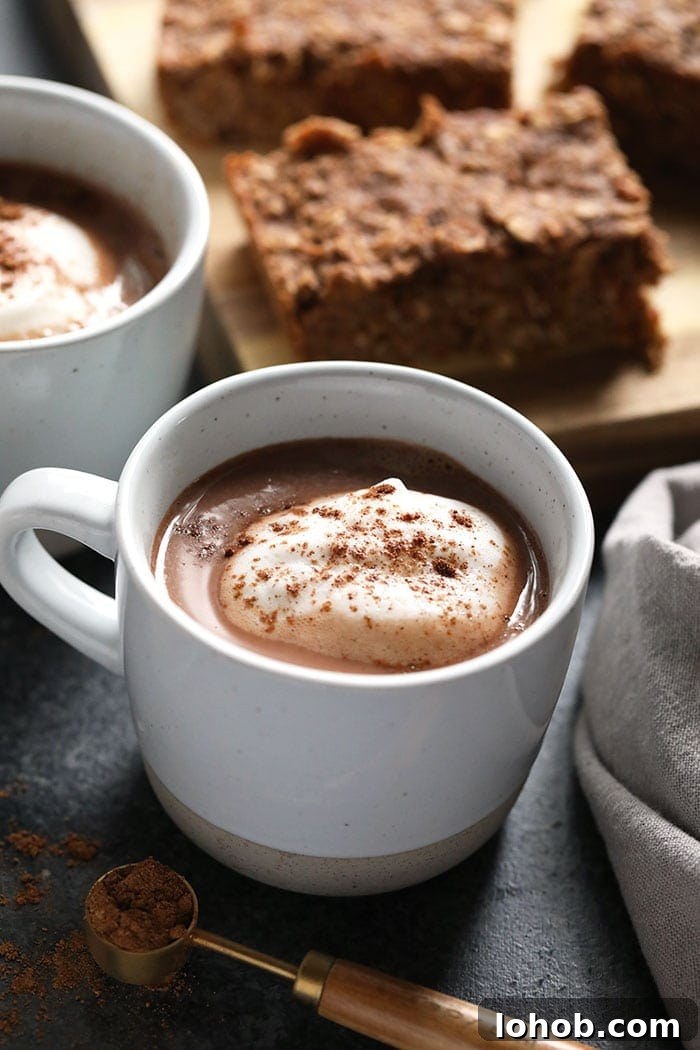 Vegan Chai Hot Chocolate that's ready to drink in 5 minutes! This delicious vegan hot chocolate is low calorie, creamy and full of chai flavor. Make this homemade chai hot chocolate recipe today! vegan chai hot chocolate in a mug