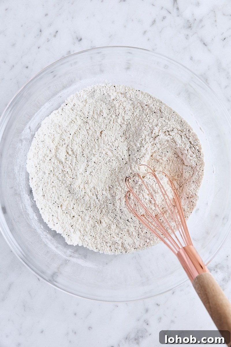 Lemon Poppy Seed Muffins Recipe — Moist, Zesty Morning Treat 5 Dry ingredients whisked together in large glass bowl