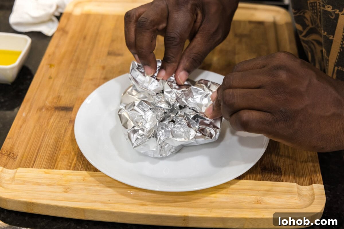 closing aluminum foil around garlic bulbs