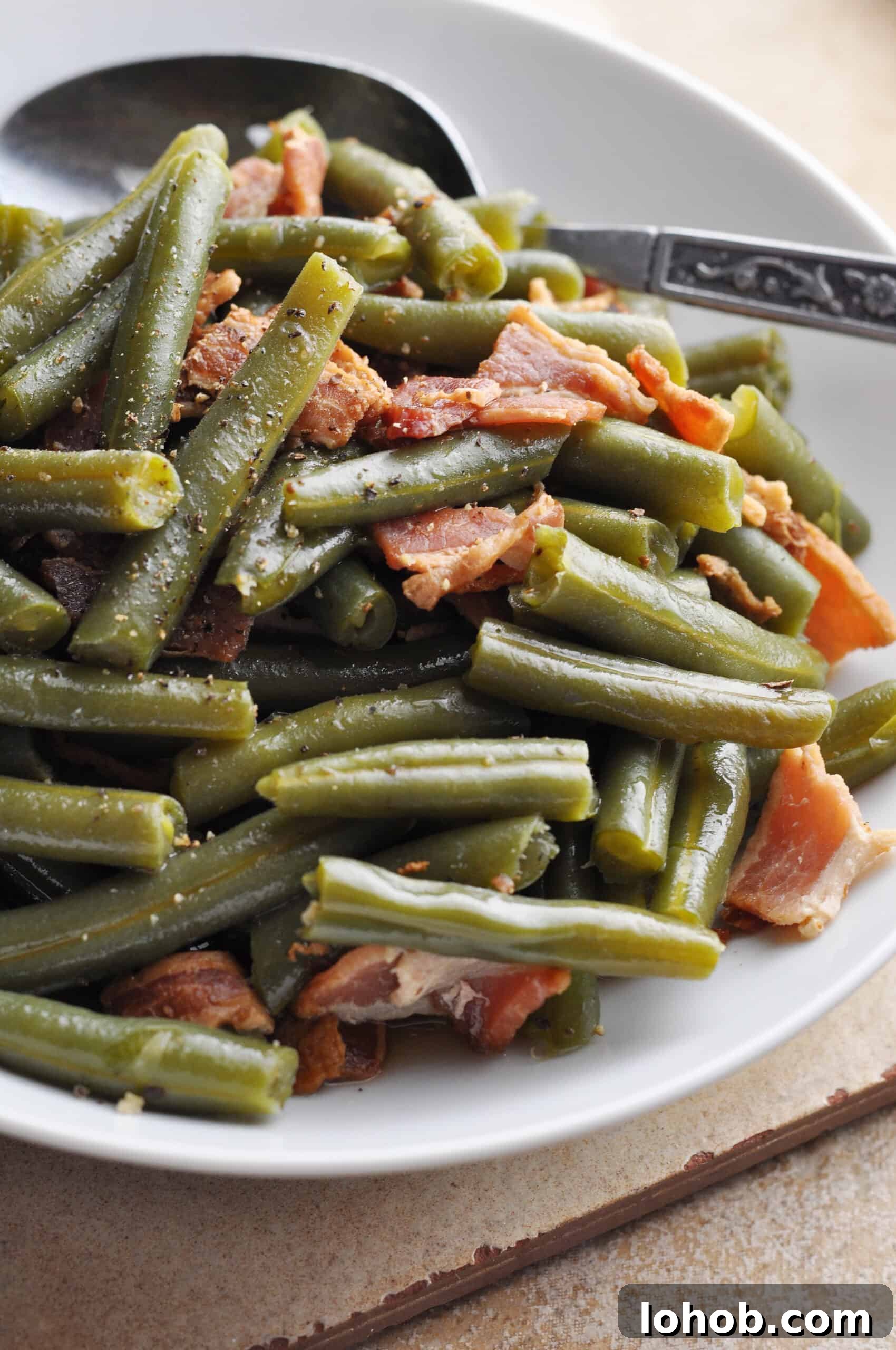 Southern green beans with bacon on platter ready to serve.