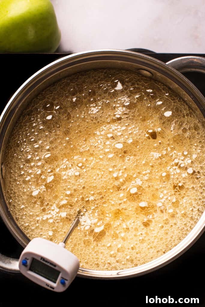 A saucepan of boiling undyed sugar candy mixture.