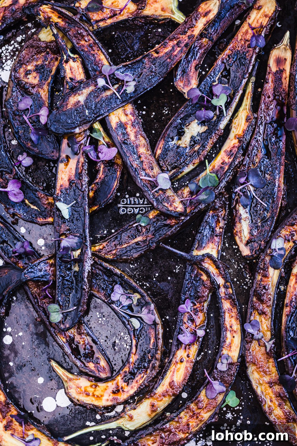 Up close and overhead shot of charred ginger-miso glazed eggplant.