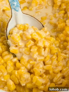 Slow cooker honey butter corn with a spoon in it.