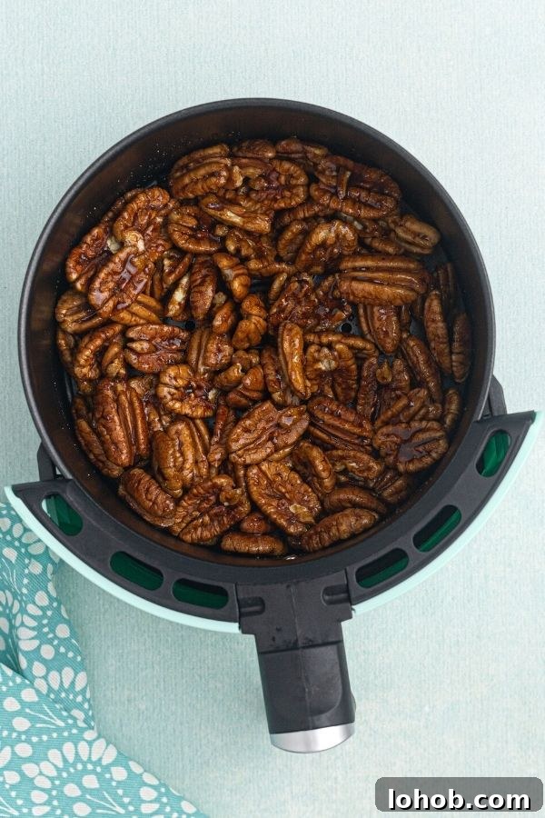 Crispy Spiced Pecans Made in the Air Fryer 4 Spiced pecans before being cooked, marinating in the air fryer basket.