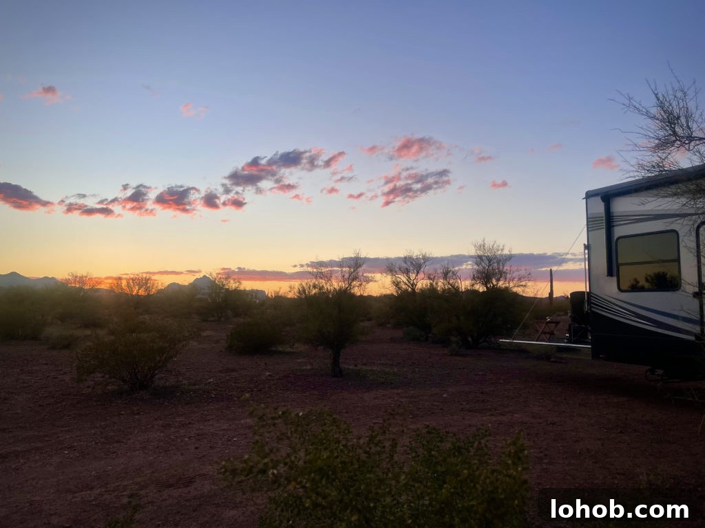 Let's Get Lost: March 2022 Travel Highlights 12 Our 5th Wheel RV parked in Ironwood Forest National Monument with the sun setting in the background.