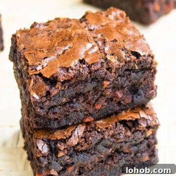 Fudgy Carrot Brownies from a Box Mix 11 Stack of Easy Chocolate Carrot Brownies (Carrot Cake Brownies) With Box Mix on Wood Background.