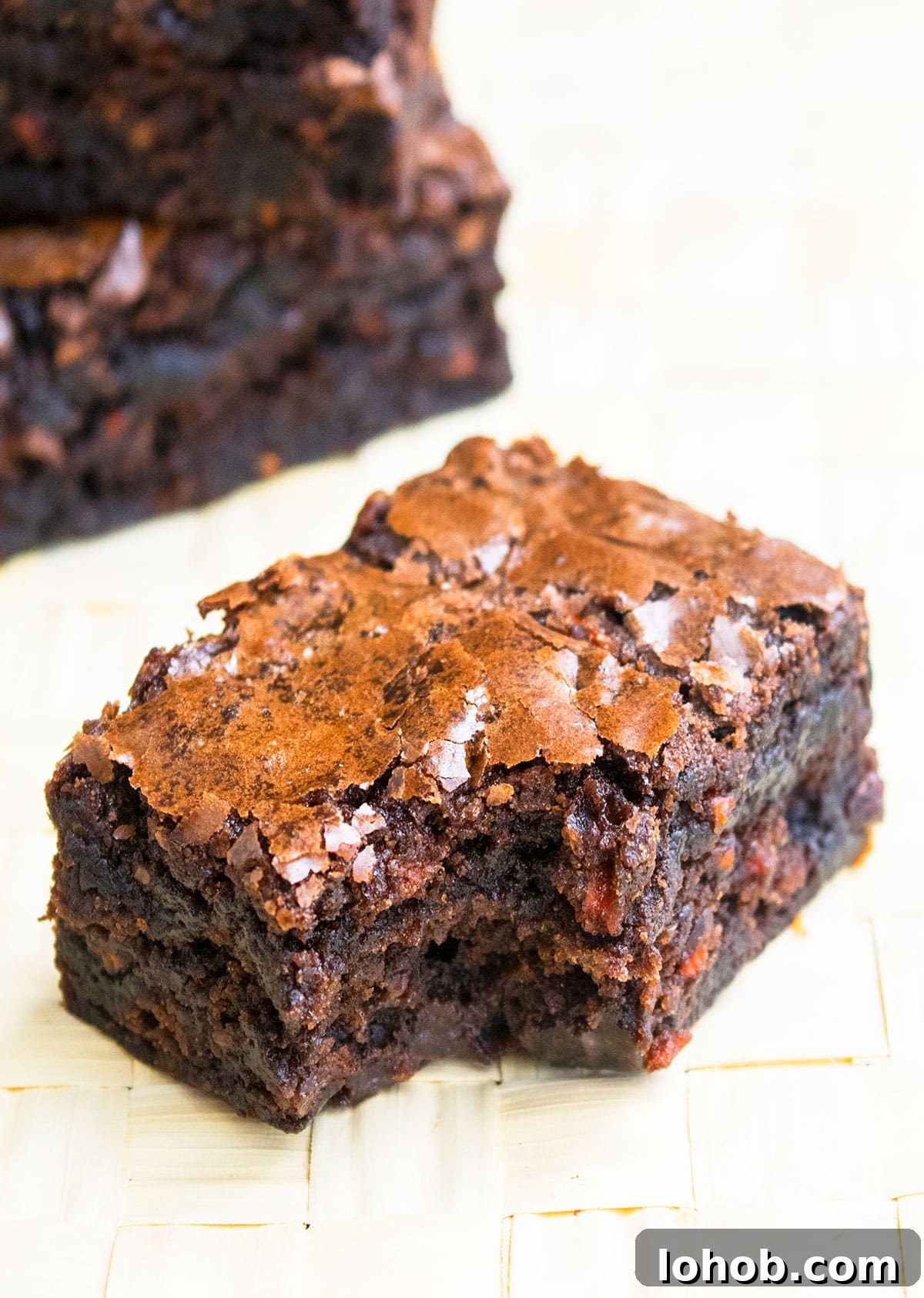 Fudgy Carrot Brownies from a Box Mix 3 Partially Eaten Slice of Brownie on Wood Background.