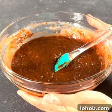 Fudgy Carrot Brownies from a Box Mix 7 Glass bowl with chocolate brownie batter.