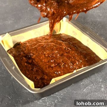 Fudgy Carrot Brownies from a Box Mix 8 Brownie batter being poured in a lined square pan.