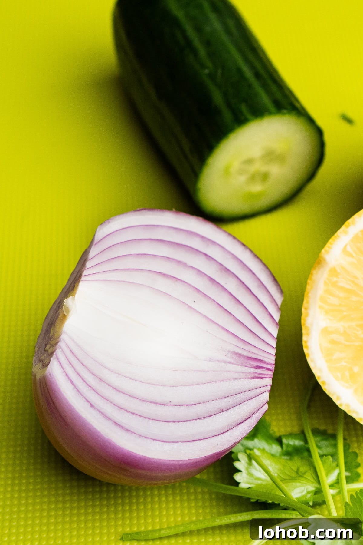 Kachumber: Tangy Indian Onion Salad 5 Half a red onion and a quarter of cucumber in the background