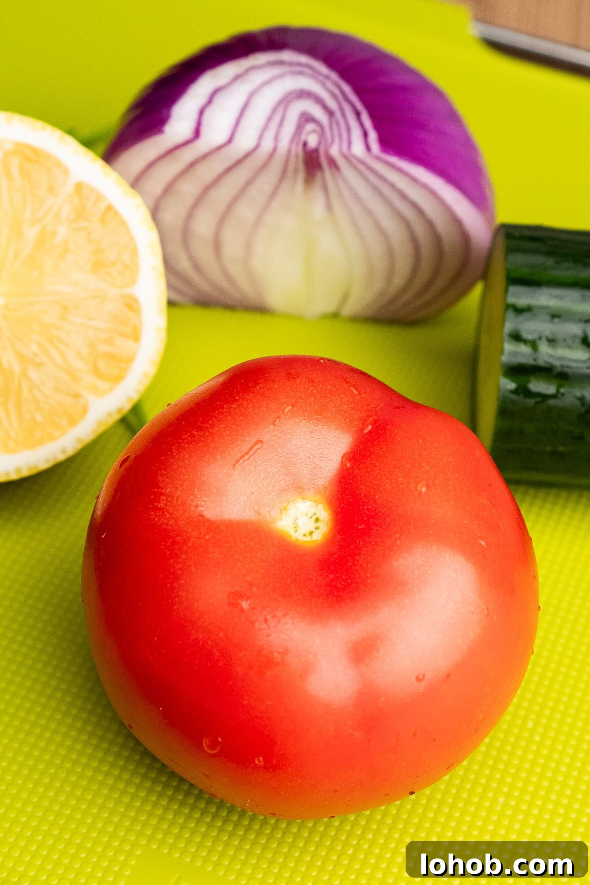 Kachumber: Tangy Indian Onion Salad 6 A tomato on a green chopping board