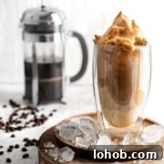 Vietnamese Iced Coffee with Condensed Milk (Cà Phê Sữa Đá) 13 Iced coffee with condensed milk in a tall glass on a wooden plate