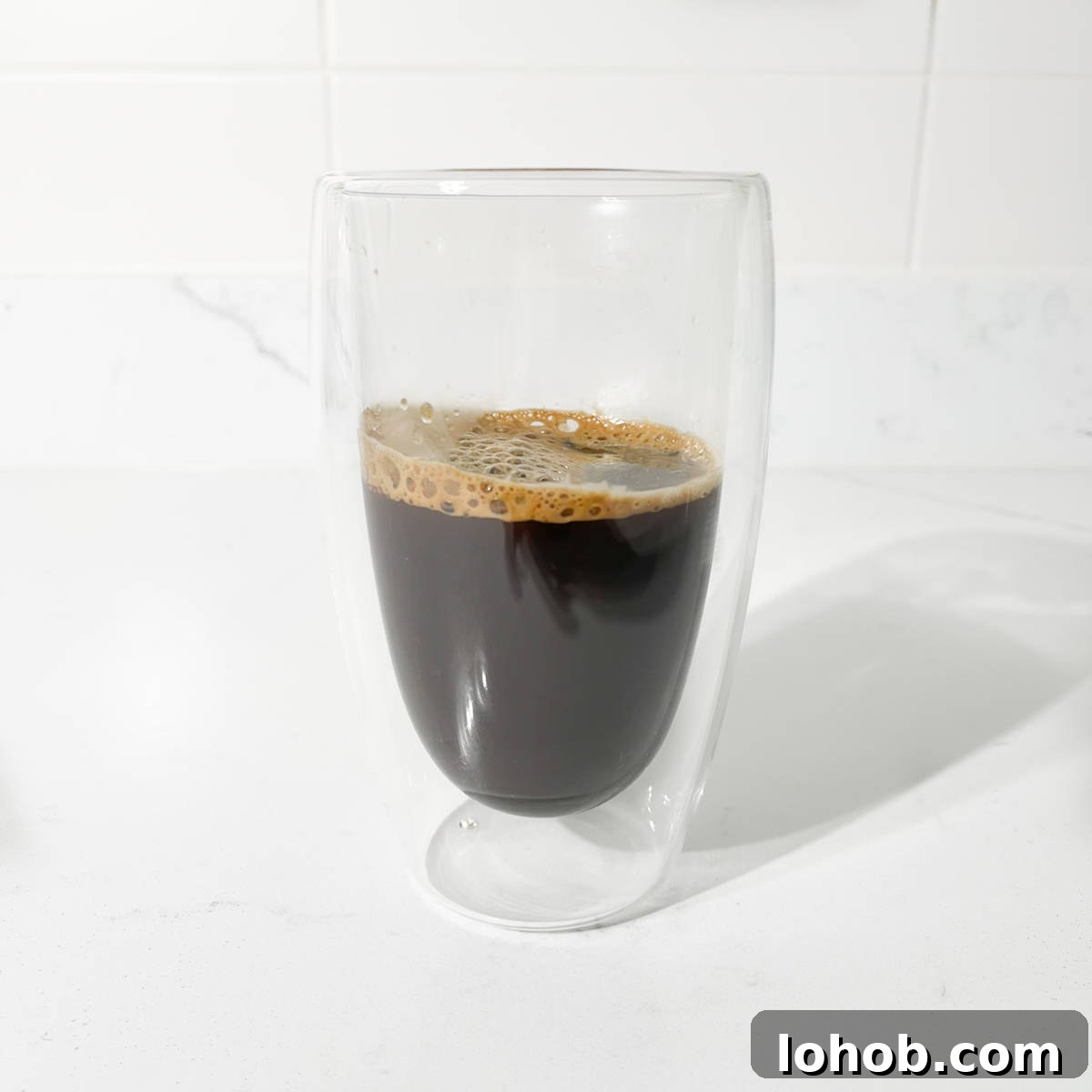 Vietnamese Iced Coffee with Condensed Milk (Cà Phê Sữa Đá) 6 Strong brewed coffee cooling in a glass for the iced coffee with condensed milk.