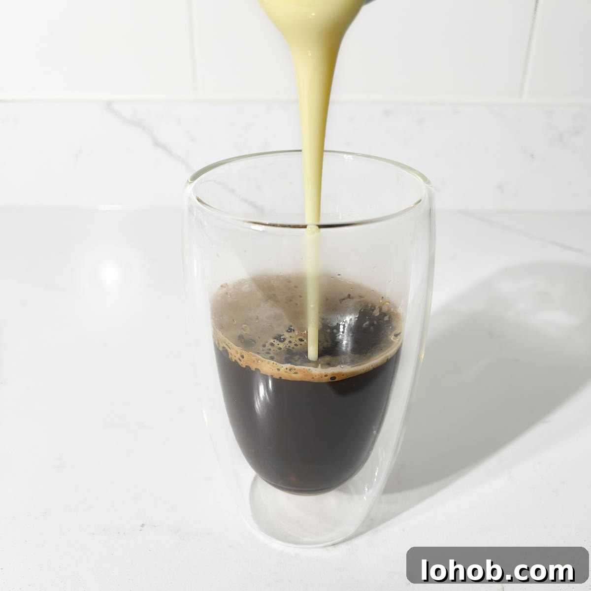 Vietnamese Iced Coffee with Condensed Milk (Cà Phê Sữa Đá) 7 Pouring condensed milk into the coffee.