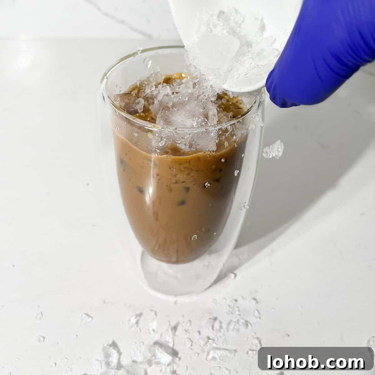 Vietnamese Iced Coffee with Condensed Milk (Cà Phê Sữa Đá) 8 Adding ice to the coffee and condensed milk.