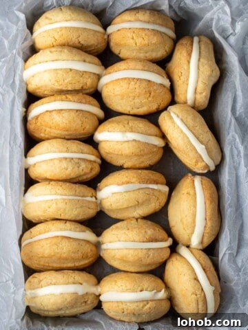 Condensed milk cookies lined up in a baking tray wrapped with baking paper.