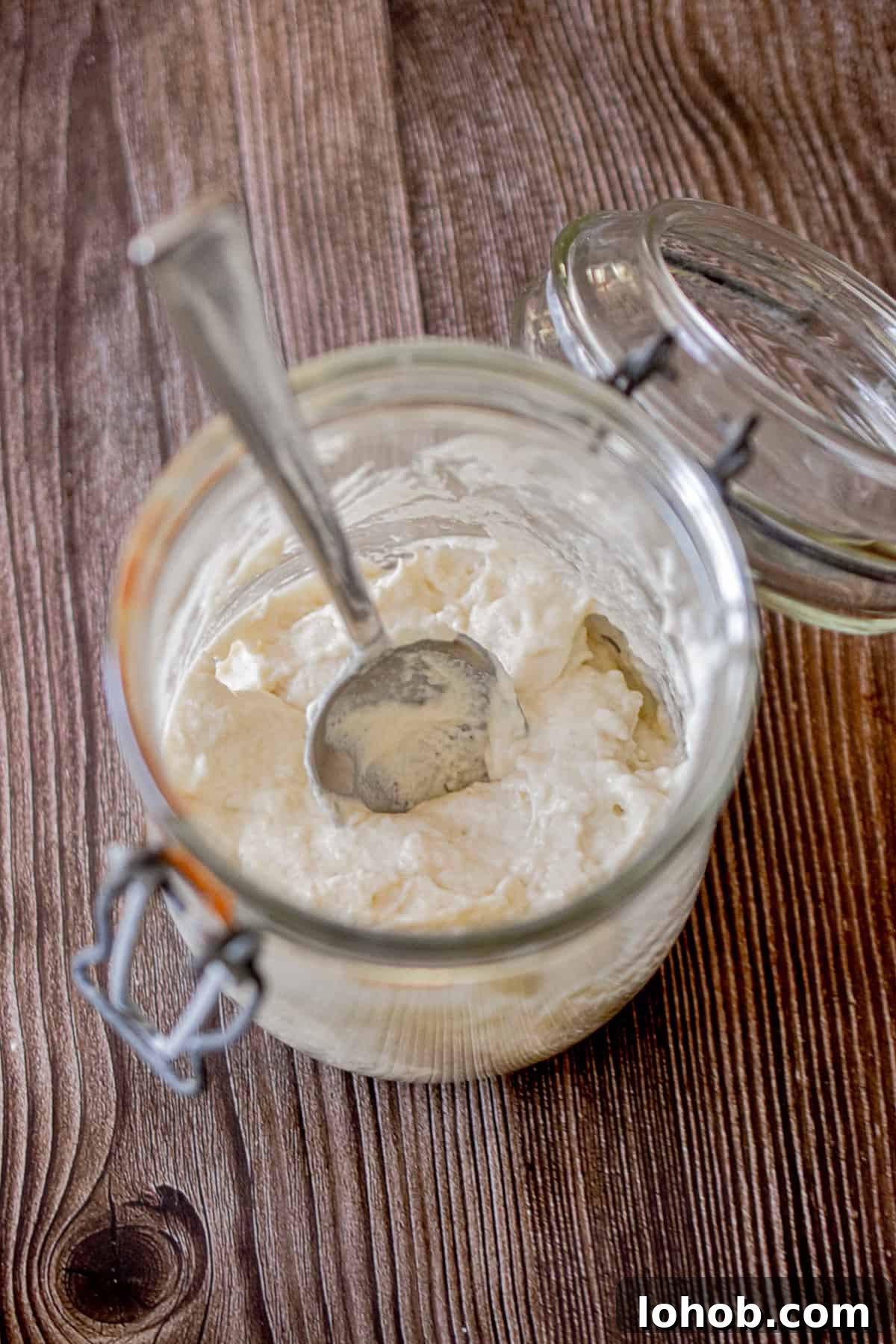 Sourdough Hydration: Mastering Dough Water Ratios 3 The ingredients for how to make a sourdough starter is in a glass jar.