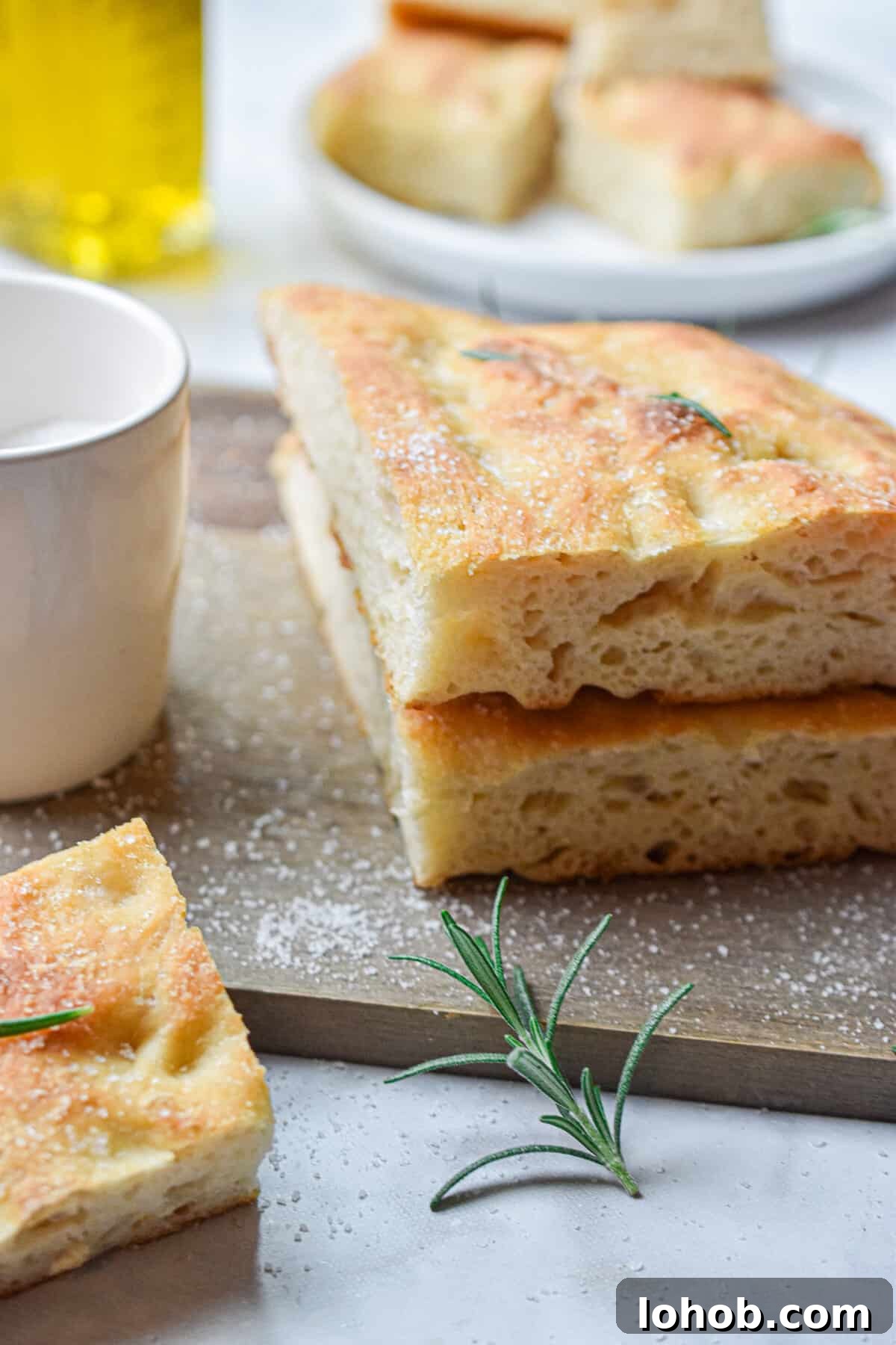 Sourdough Hydration: Mastering Dough Water Ratios 6 Sourdough focaccia is cut in half and stacked.