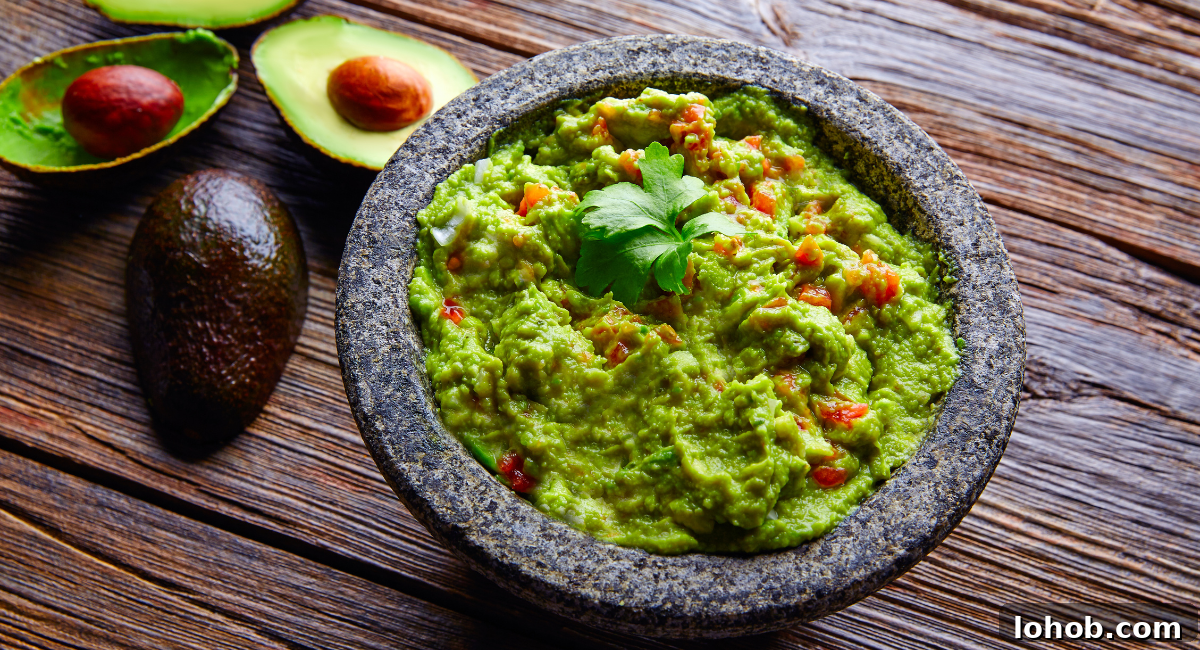 20 Simple Fish Taco Toppings to Elevate Flavor 6 Overhead image of guacamole with garnish.