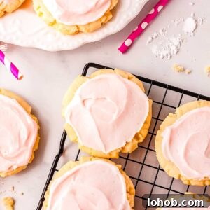 Swig sugar cookies on a wire rack and on a white serving plate.