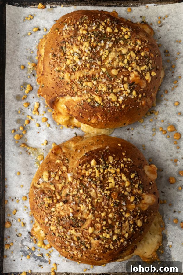 Rosemary Parmesan Loaf with Crispy Herb Crust 6 two loaves of rosemary parmesan bread on a parchment lined sheet pan