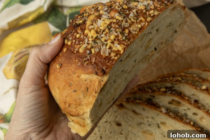 Rosemary Parmesan Loaf with Crispy Herb Crust 9 partially sliced one hour rosemary parmesan bread held in a hand