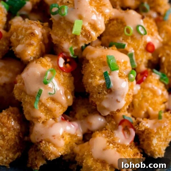 Smoky Roasted Cauliflower Salad with Garlic Lemon Dressing 6 Close up of Crispy Cauliflower with bang bang sauce topped with chillies and spring onions